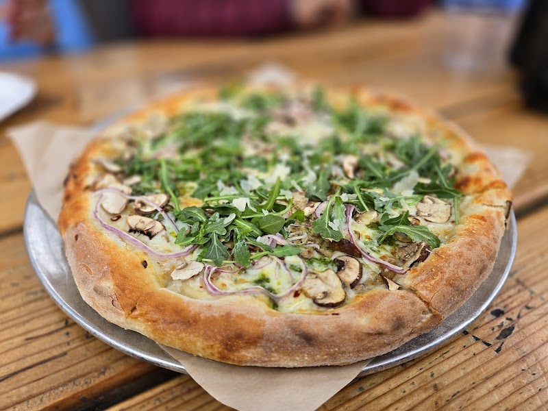 Thin-crust arugula mushroom pizza