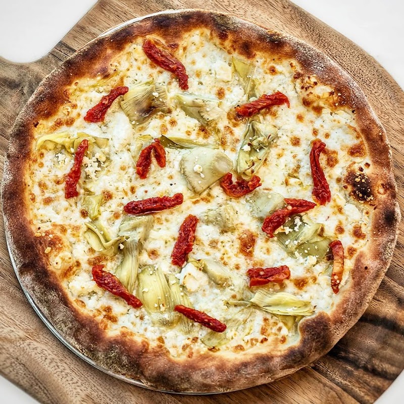 Artichoke white pizza, wood board