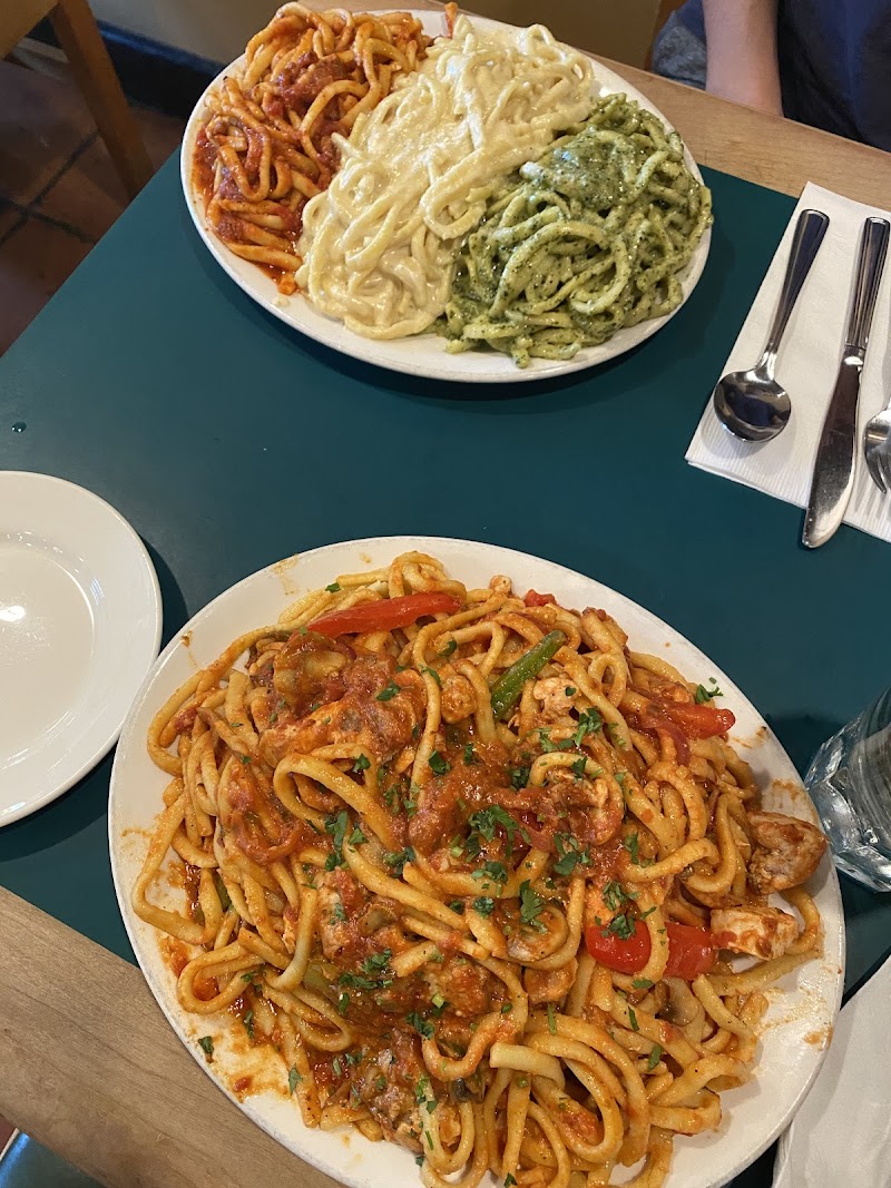 Heaping pasta plates, table full