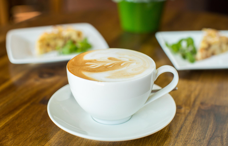Latte art, warm wooden table