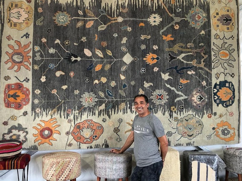 Owner beside statement rug