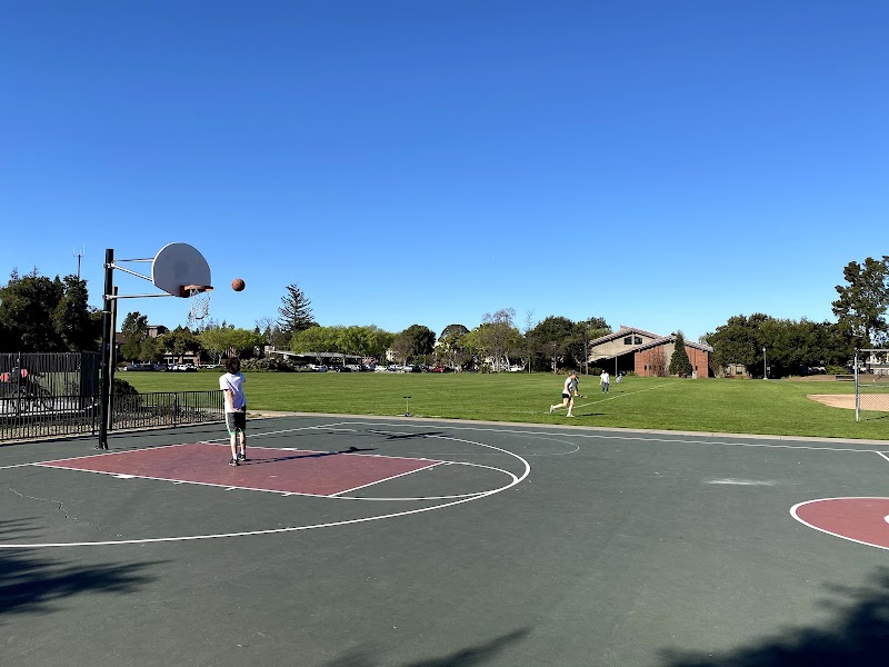 Basketball court, green fields beyond