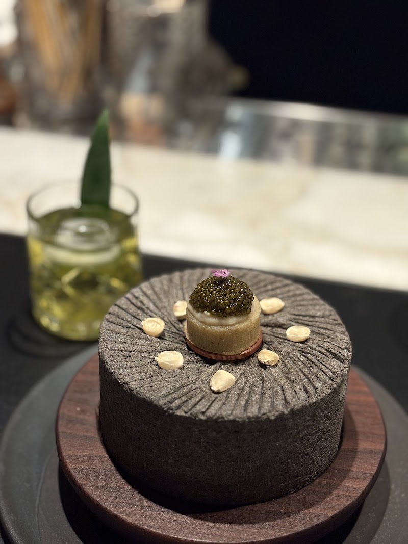 Caviar-crowned bite, stone vessel