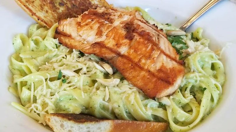 Grilled salmon over herb pasta