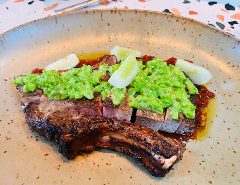 Charred ribs, vibrant herb sauce