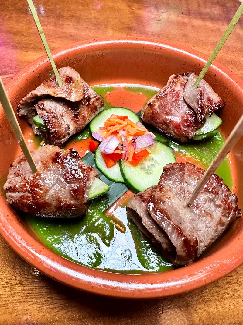 Grilled beef skewers, vibrant sauce