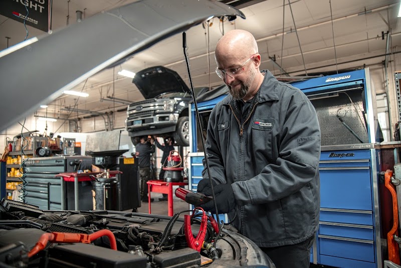 Technician inspecting engine with care