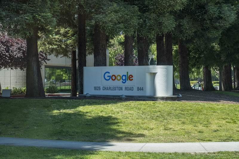 Tree-lined campus entrance sign