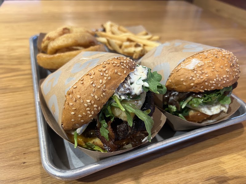 Stacked burgers, golden fries