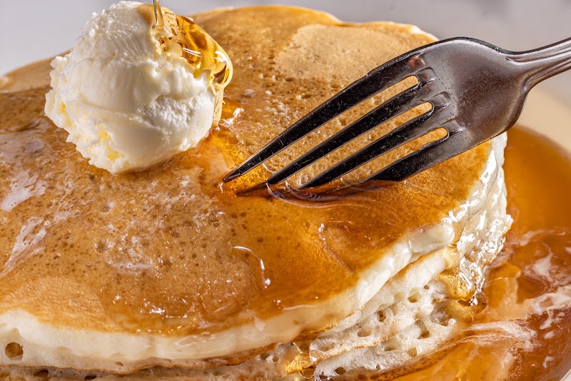 Golden pancakes, syrup drizzle