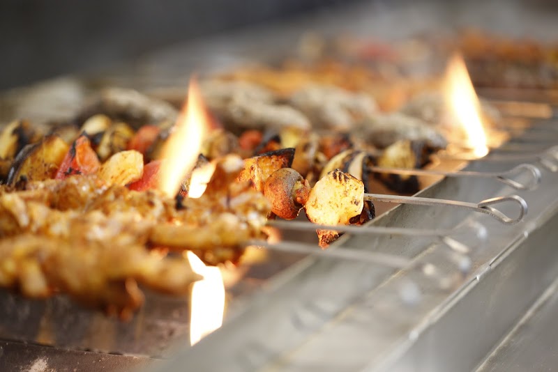 Skewers grilling over open flame