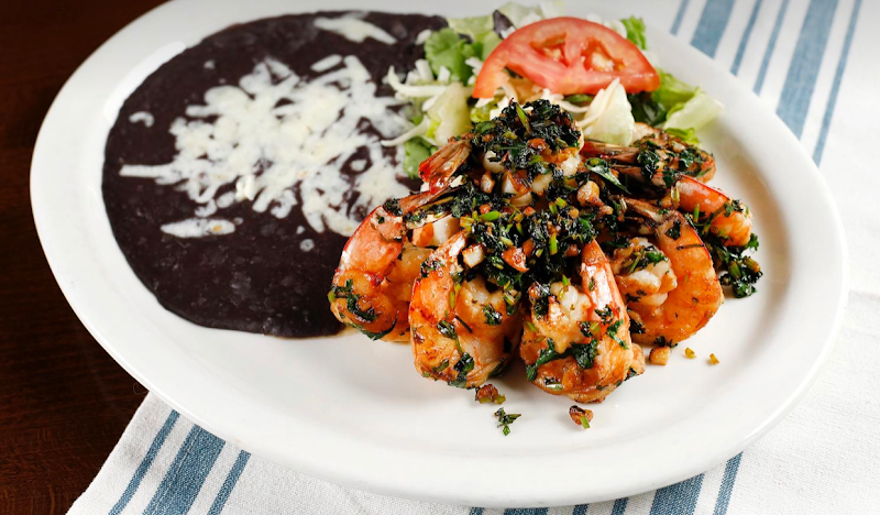 Herb-crusted shrimp, rich beans