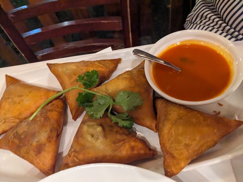 Crispy samosas, vibrant dipping sauce