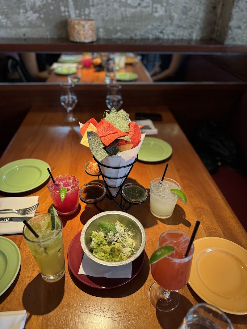 Guacamole, chips, vibrant margaritas
