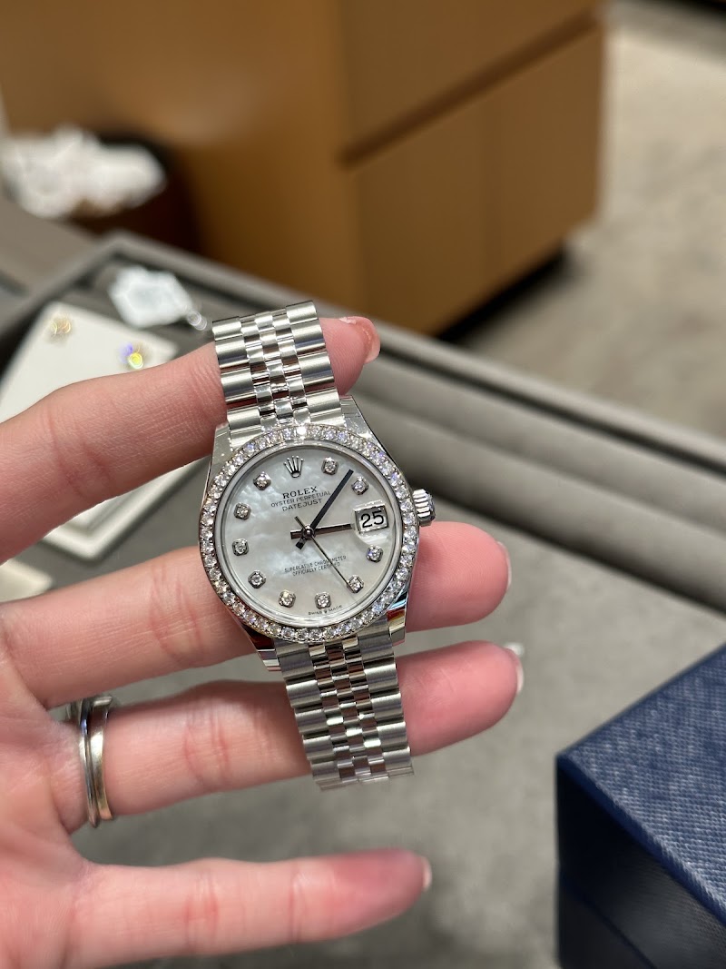 Diamond dial watch in hand