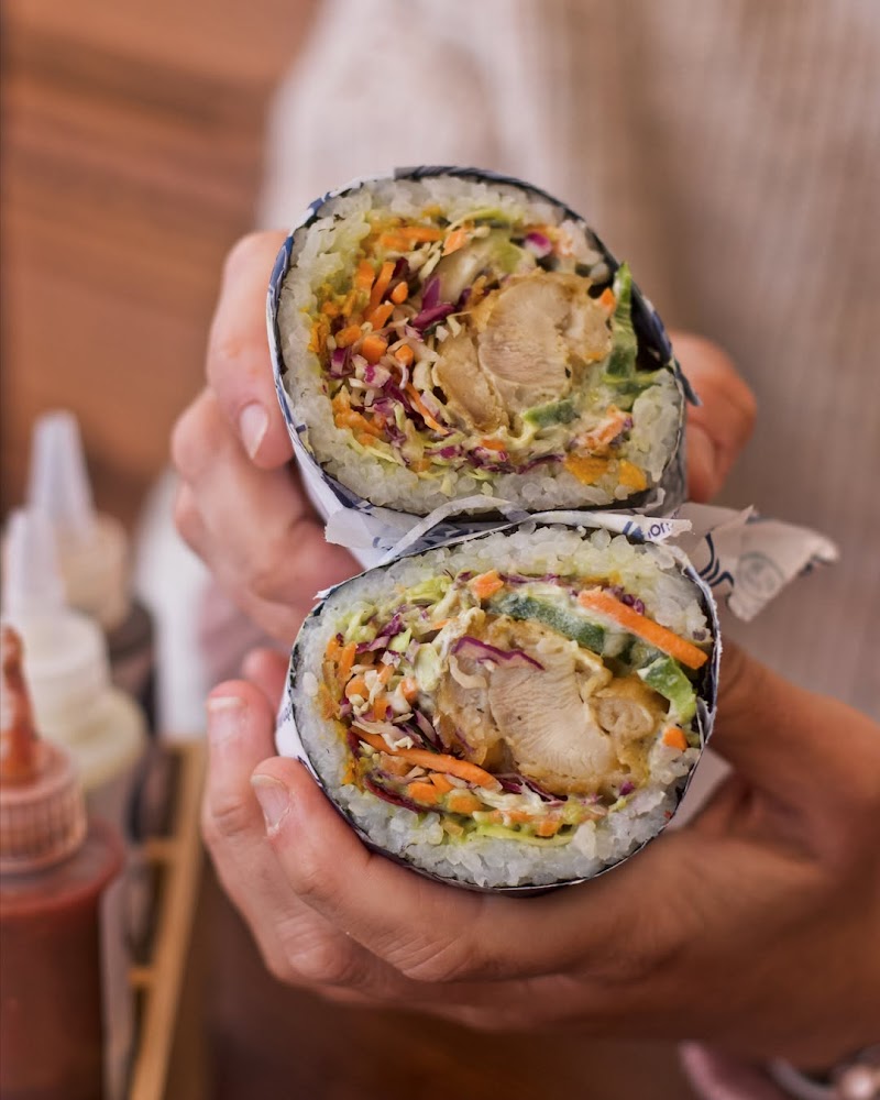 Colorful sushirrito held close