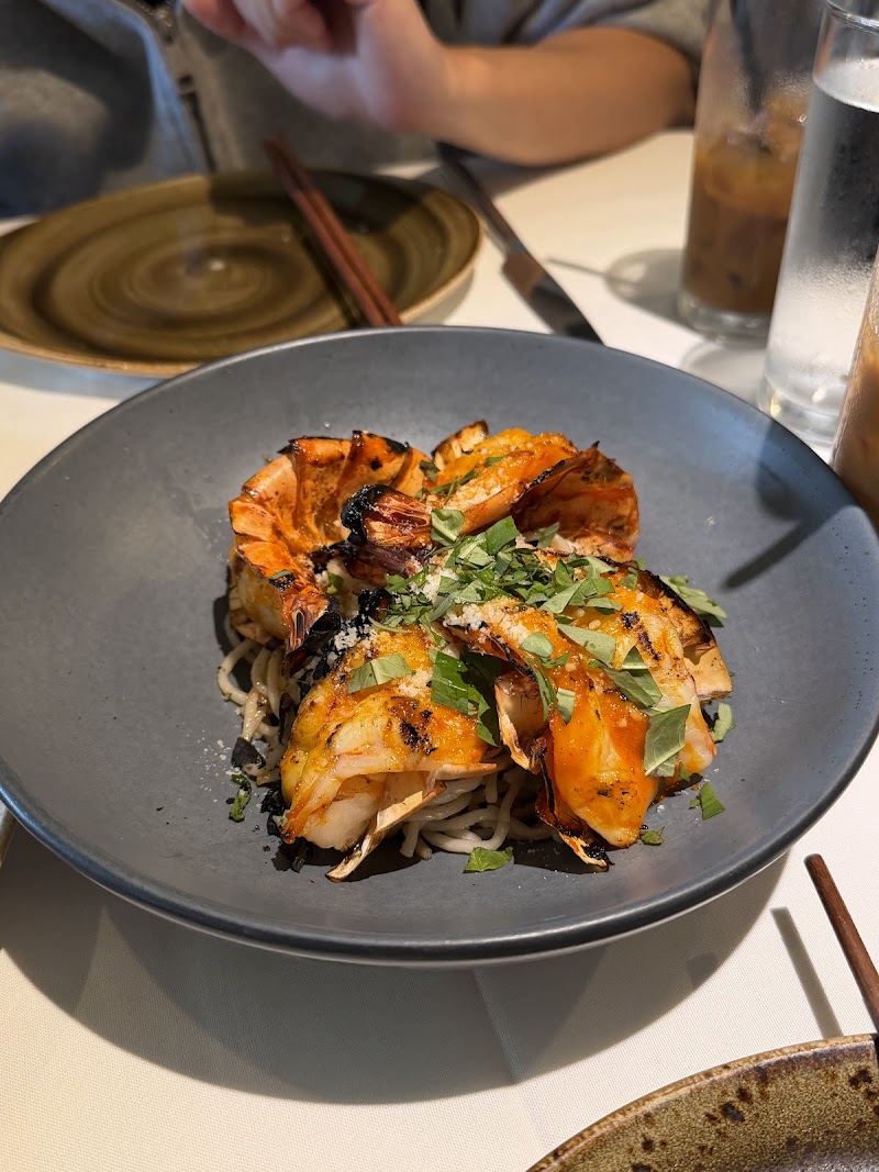Charred prawns over noodles