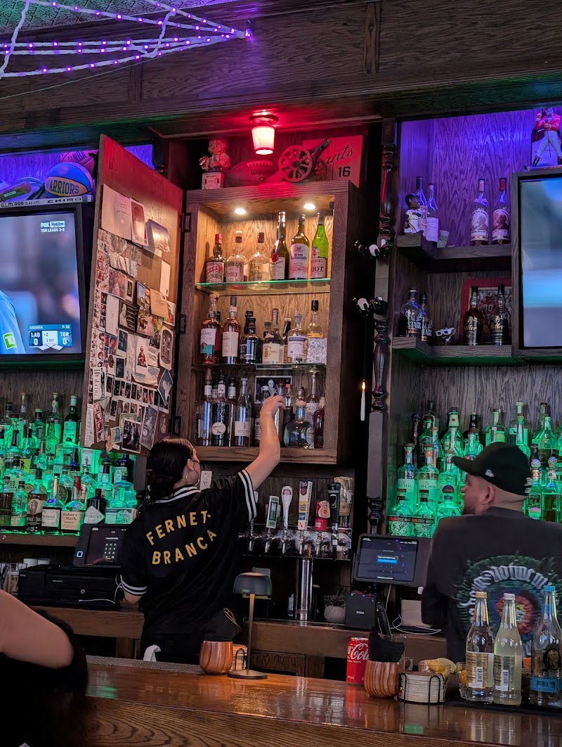Bartender reaching for spirits