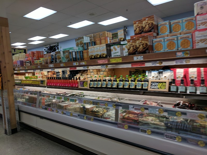 Well-stocked refrigerated grocery aisles