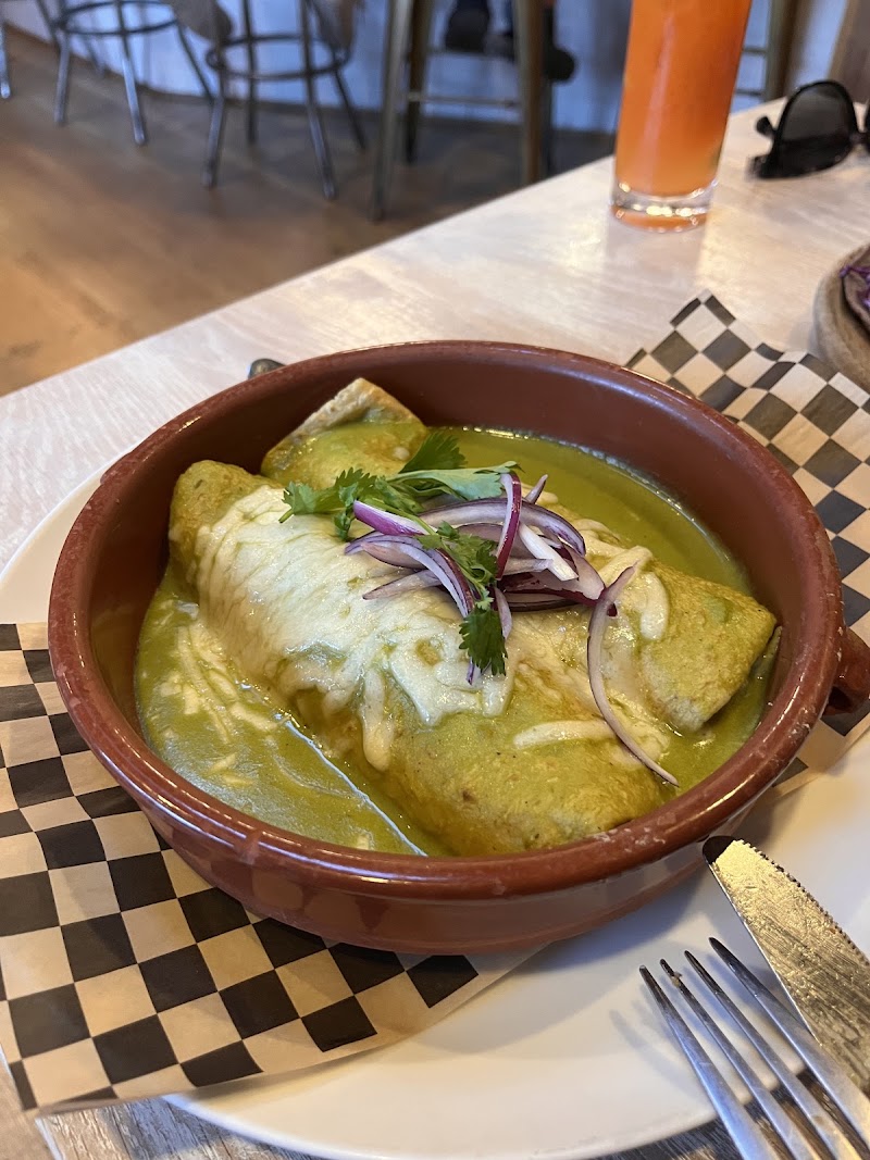Green enchiladas, rustic clay bowl